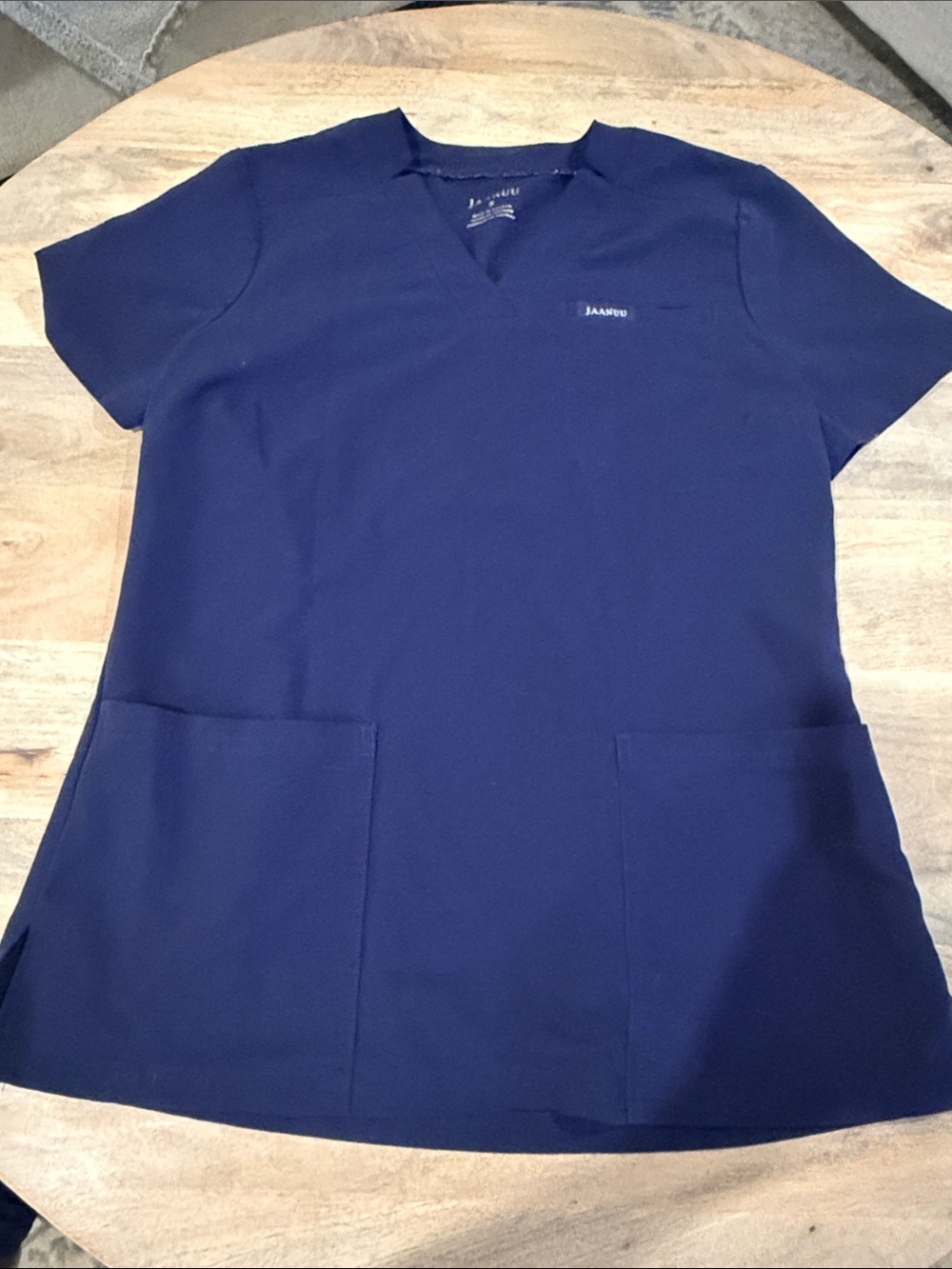 Jaanuu scrub top size small navy blue with two front pockets